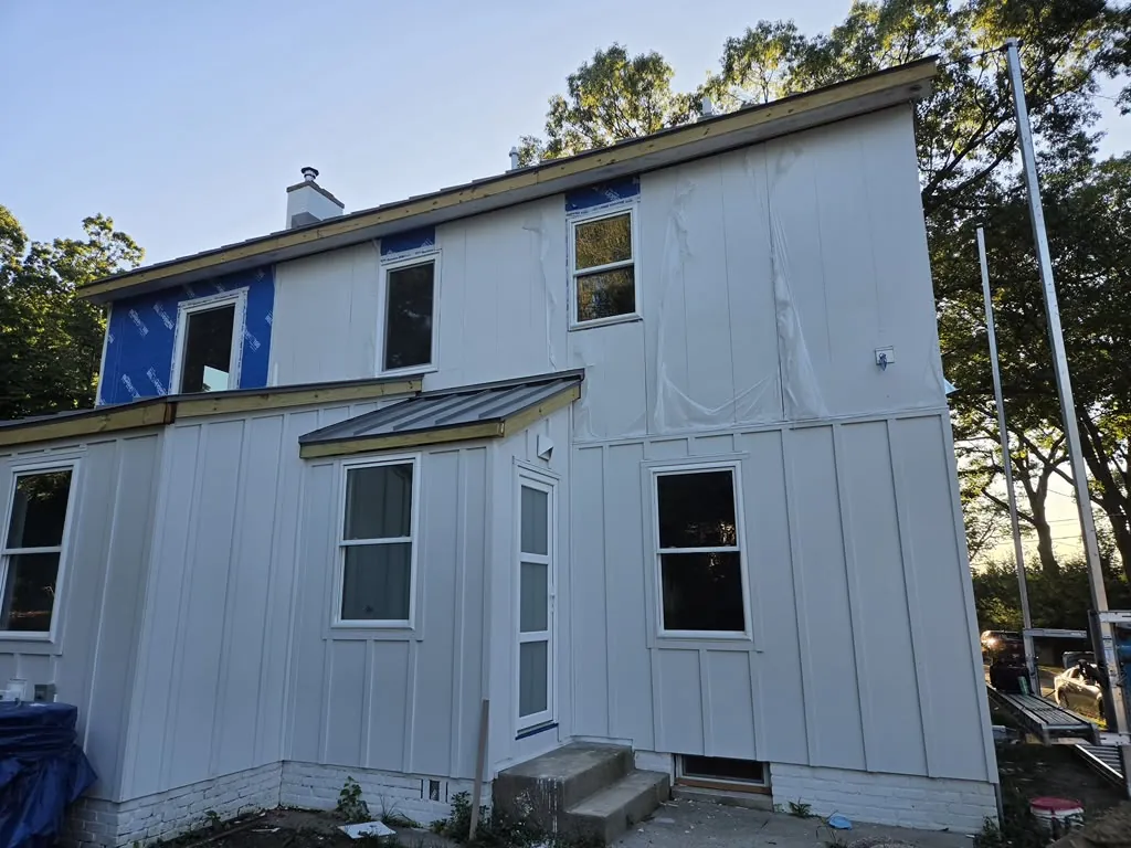 Finished white board and batten siding in golden hour light