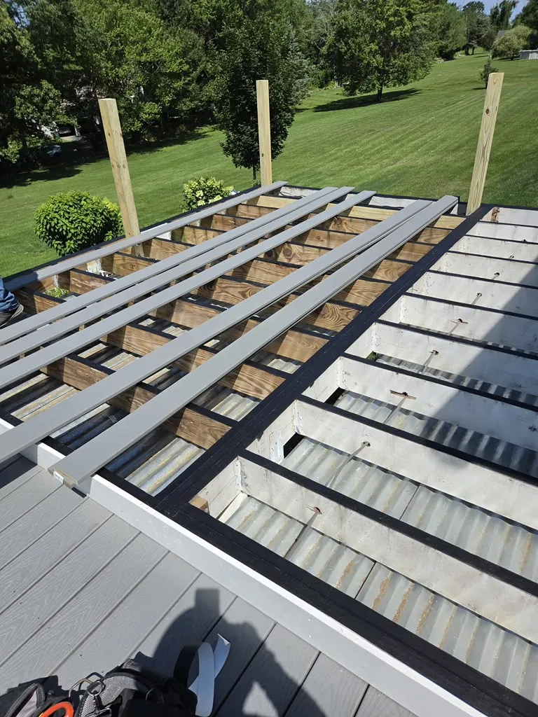 Composite decking installation with aluminum joists on a rooftop deck