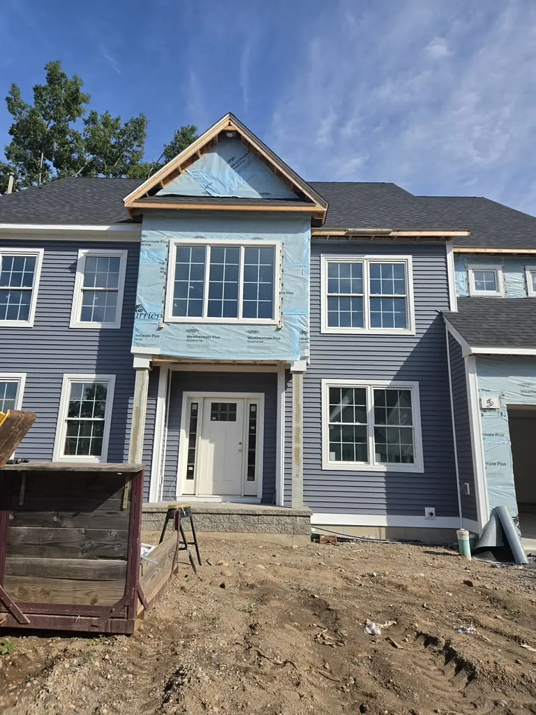 New construction home with blue-gray horizontal siding and white trim